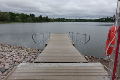 Pier over lake against sky