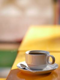 Close-up of coffee cup on table