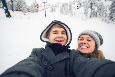 Portrait of smiling woman in snow