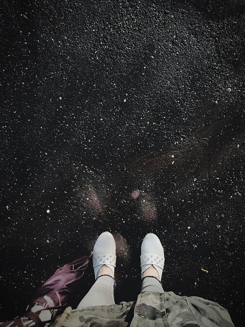 LOW SECTION OF PERSON STANDING AGAINST STAR FIELD AT NIGHT