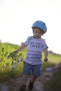 Full length of boy standing on field