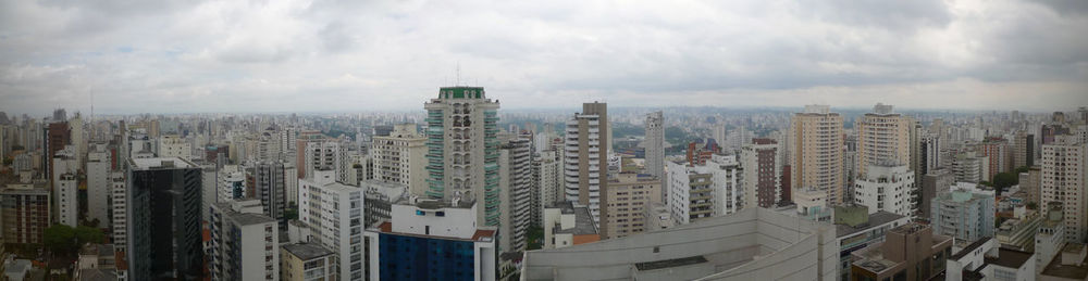 Panoramic view of buildings in city against sky