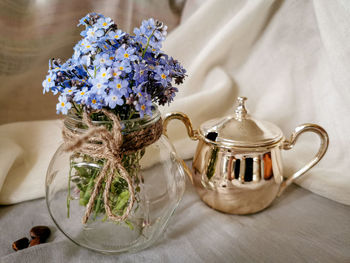 Close-up of purple and white flowers in vase