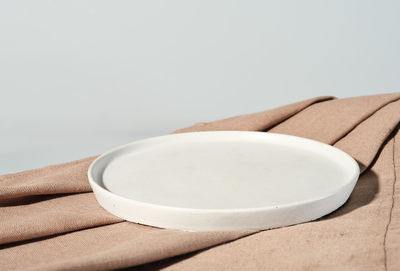 Empty stand plate on a canvas beige napkin. mock up, template for menu.  food presentation. 