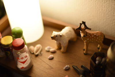 High angle view of toys by illuminated lamp on table at home