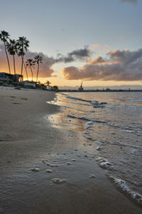 Scenic view of beach against sky during sunset