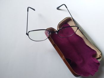 High angle view of sunglasses hanging against white background