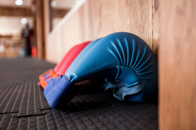 Close-up of boxing gloves on floor