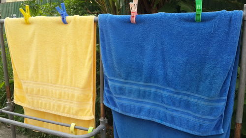 Close-up of towels drying on rack
