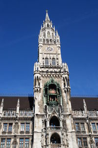 Low angle view of bell tower against blue sky