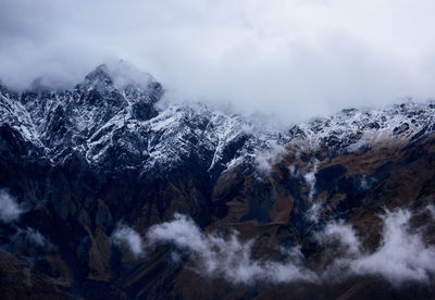 High angle view of snow covered mountains against sky