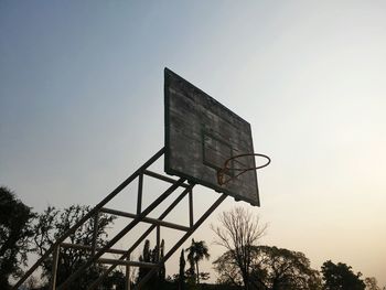 Low angle view of damaged basketball against clear sky on sunny day