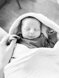 Portrait of newborn baby holding on to mothers hand 