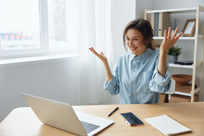 Young woman using laptop at office