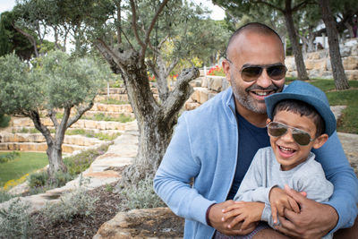 Portrait of smiling man with son