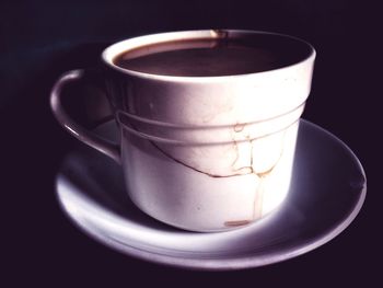 Close-up of coffee cup against black background