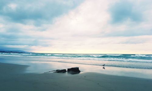 Scenic view of beach against sky during sunset