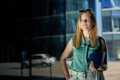 Young woman looking away in city