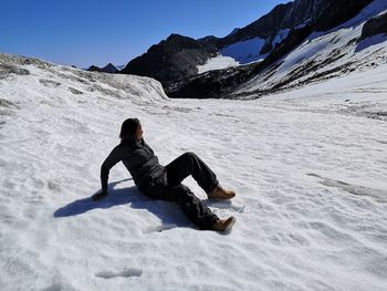 Full length of person on snowcapped mountain during winter