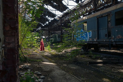 Side view of woman standing by building