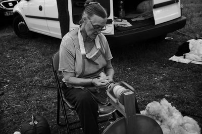 Midsection of woman sitting on field