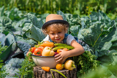 Portrait of cute girl with vegetables