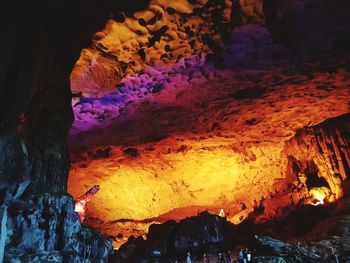 Close-up of illuminated cave against sky