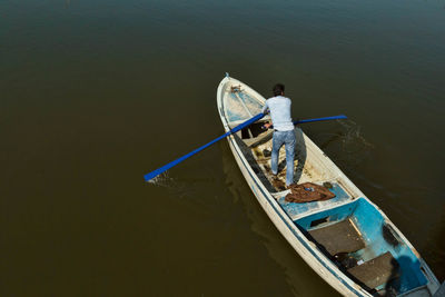 High angle view of man working in boat