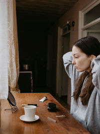 Portrait of young woman sitting at home