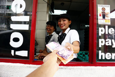 Portrait of a smiling young couple holding camera