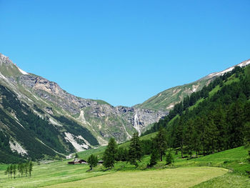 Scenic view of mountains against clear blue sky