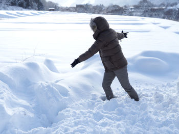 Full length of child on snow covered land
