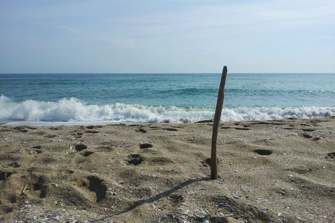 sea, horizon over water, water, beach, shore, wave, scenics, tranquility, tranquil scene, beauty in nature, sky, nature, idyllic, remote, day, no people, coastline, outdoors, non-urban scene, seascape, calm, ocean, wooden post, cloud