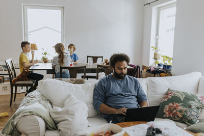 Man working from home and taking care of children