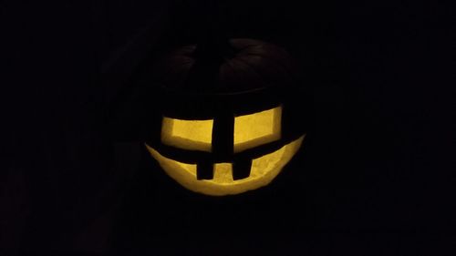 Close-up of illuminated pumpkin against black background