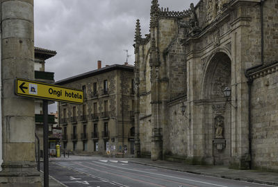 Road by building against sky