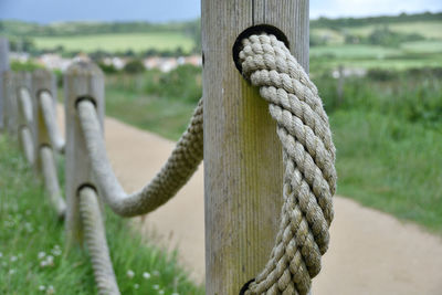 Close-up of rope tied on wooden post