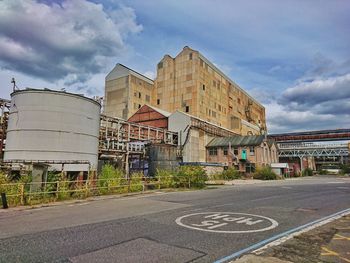 Road by building against sky