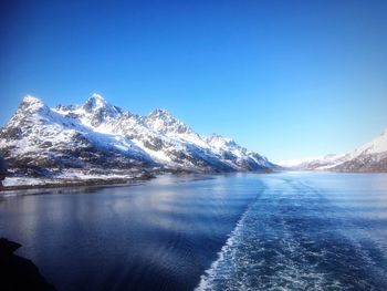 Scenic view of snowcapped mountains against clear blue sky