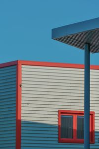 Low angle view of building against clear blue sky
