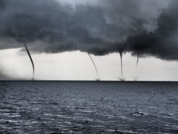 Scenic view of sea against storm clouds