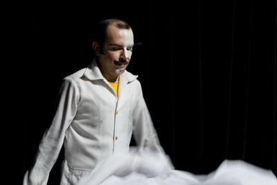 Actor standing on stage before theatrical performance.