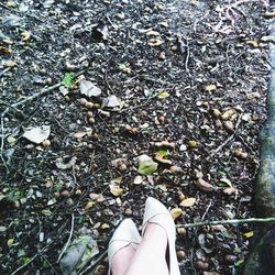 Low section of person standing on tiled floor