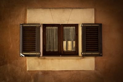 Closed window of town building at night