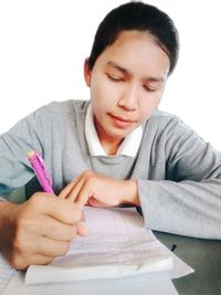 Portrait of a beautiful young woman sitting on table