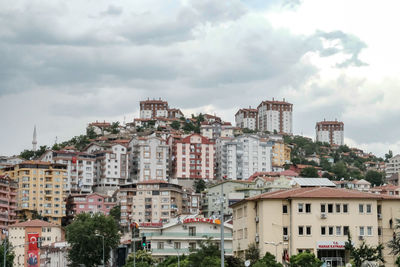 Buildings in town against sky