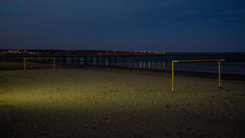 Bridge over sea against sky at sunset