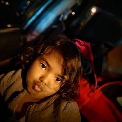 Portrait of cute baby girl in car