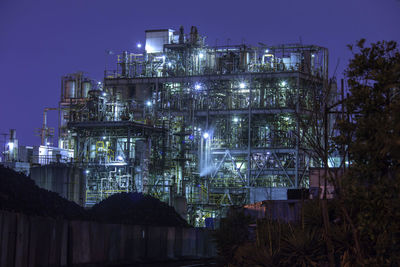 Low angle view of illuminated buildings against sky at night