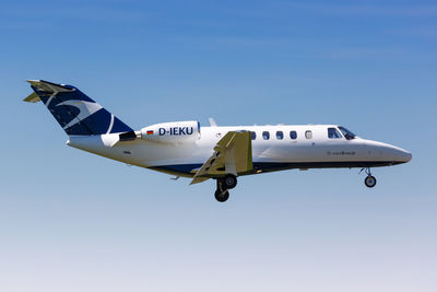 Airplane flying against clear blue sky